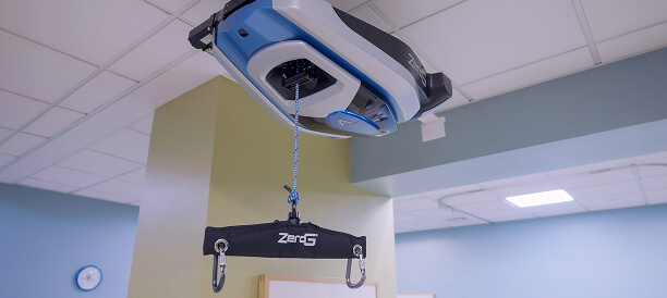 A ceiling-mounted ZeroG patient lift system is installed in a Hauser Rehabilitation Center room.
