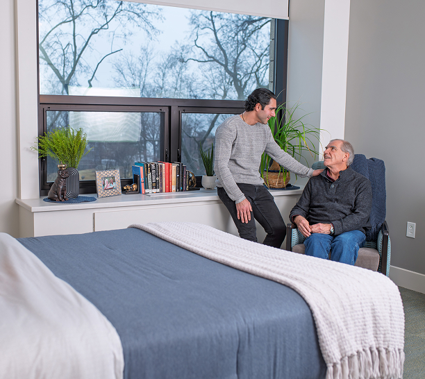 Family visit in a private memory care room at RiverSpring Living