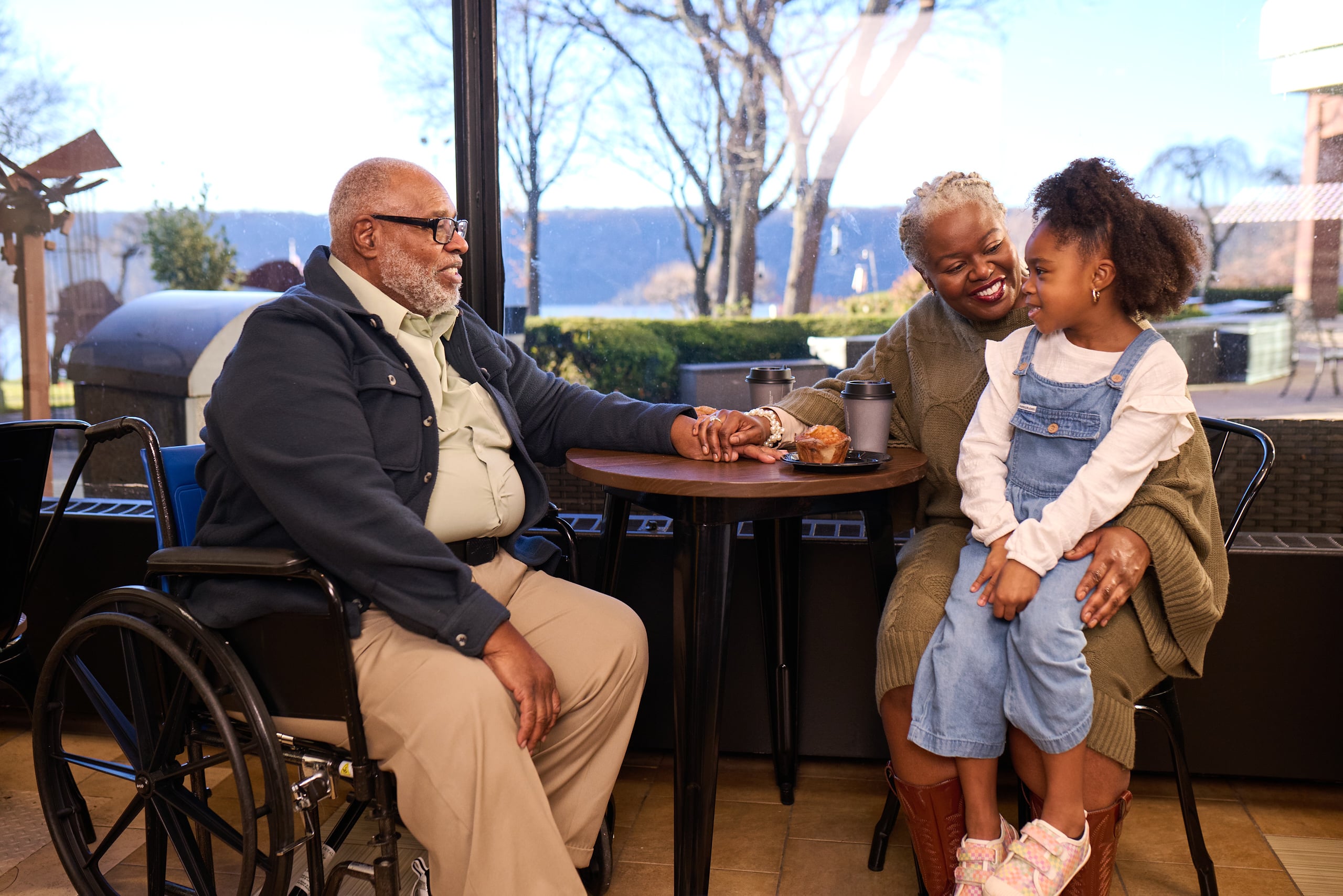 Older adults spending time with a young child during a family visit at a senior living community